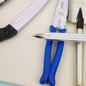 Macro detail of creative tool-shaped ballpoint pens in realistic wrench and plier designs