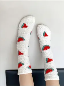 Close-up of thick coral fleece socks with cute watermelon patterns for winter warmth