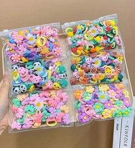 Close-up of colorful cartoon hair ties for children in various animal and flower shapes