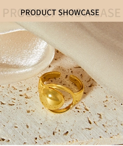 Detail of gold hollow moon ring on beige stone texture with elegant satin background