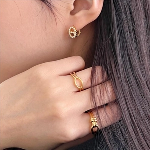 Close-up of golden geometric S925 silver jewelry set with elegant earrings and rings