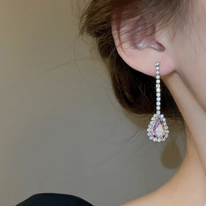 Macro detail of drop-shaped pink crystal earrings with sparkling rhinestone settings