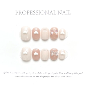 Detailed set of handmade soft pink press-on nails with 3D hearts and bow decorations