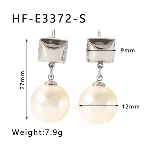 Detail showing 27mm geometric pearl earrings with precise 12mm bead diameter and weights