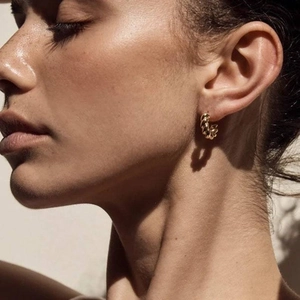 18K gold plated stainless steel twisted hoop earrings on a model for a minimalist look