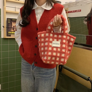 Cute red and white checkered lambswool tote bag shown in a cozy cafe setting
