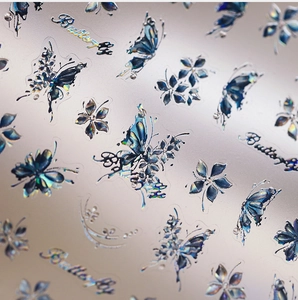 Macro detail of laser holographic butterfly and floral nail art stickers with metallic finish