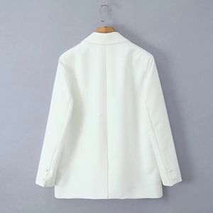 Detail view of the back of a white tailored blazer with back darts and smooth fabric