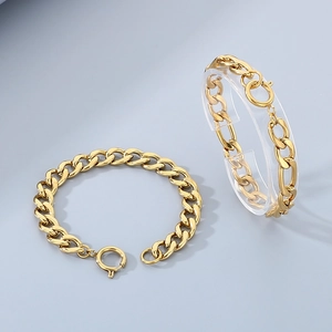 Gold stainless steel Cuban chain bracelet with spring ring clasp on display stand
