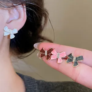 Sweet bow-shaped stud earrings set with sparkling rhinestones in four elegant colors