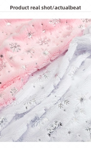 Close-up of plush fabric with silver foil snowflakes in pink and white for floral wrapping