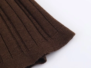 Close-up of brown ribbed knit texture and stitching details of a two-piece sweater set