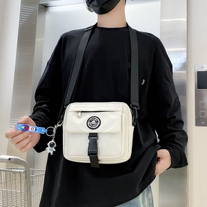 Japanese techwear style white crossbody bag with adjustable strap and astronaut keychain