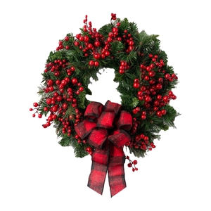 Christmas wreath with green pine needles, red berries, and buffalo plaid bow decoration