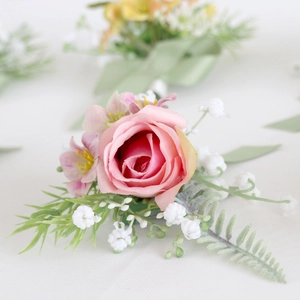 Pink artificial rose boutonniere with baby's breath for wedding groom and bride