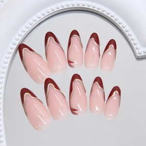 French wine red press on nails with gold wavy edges and long almond shape on mirror