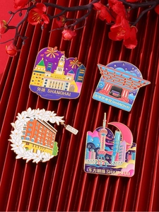 Set of four metal enamel Shanghai landmark magnets on elegant red textured background