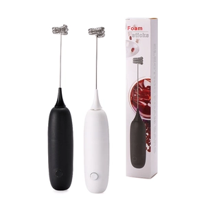 Electric milk frother set in black and white with metal whisk and foam stick packaging