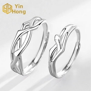 Detail of silver couple rings with minimalist twisted design and adjustable open bands