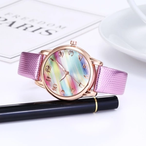 Macro shot of colorful gradient dial watch with rose gold case and pink textured strap