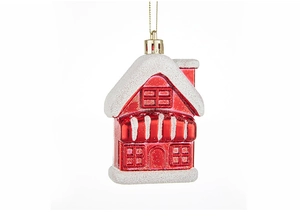 Detail of red Christmas house ornament with glittery snow and golden hanging loop