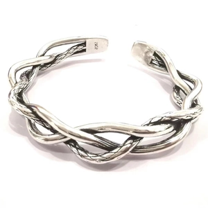Detailed macro view of S925 sterling silver hallmark on twisted woven open cuff bracelet