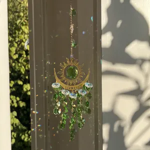 Golden sun and moon crystal suncatcher with green beads and rainbow prism reflection