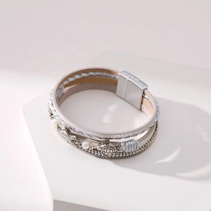 Detail of bohemian layered bracelet with starfish and sea turtle charms and magnetic buckle