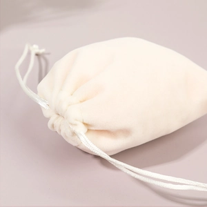 Elegant beige velvet drawstring jewelry pouch made of high-quality soft fabric