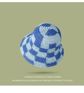 Detailed view of woven checkerboard sun hat in blue and white with wide brim