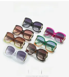 Detailed display of square fashion sunglasses in multiple colors with gold metal trim
