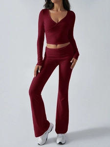 Close-up detail of burgundy V-neck crop top and high-waisted flared knitted trousers set