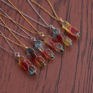 Rainbow crystal pendant necklaces with gold and silver chains on wood background