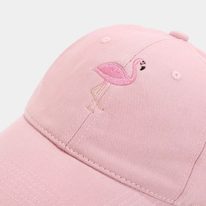 Close-up of pink cotton baseball cap with detailed flamingo embroidery and fine stitching