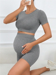 Close-up of seamless ribbed grey maternity activewear set featuring high-waist shorts