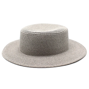 Detailed close-up of the woven texture and flat top design of this straw boater hat