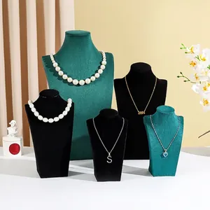 Elegant velvet portrait necklace display stands in black and green for jewelry shop window