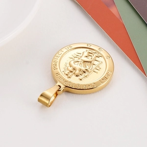 Detailed close-up of a gold Saint Christopher medallion pendant with relief engraving
