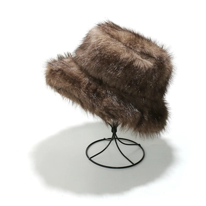 Detail showing the thick brown faux fur texture of the warm winter bucket hat on a stand