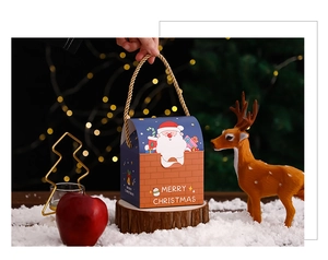 Blue and red Christmas gift box with reindeer and Santa Claus prints in warm setting