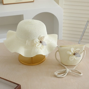 Detail of straw hat and matching bag set with lace flowers and pearls for girls