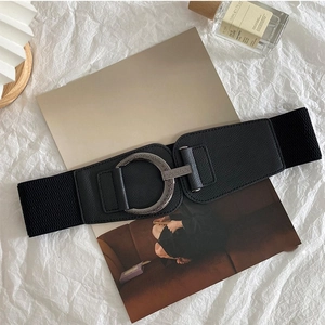 Women's black elastic waist belt with a vintage silver round buckle for dresses