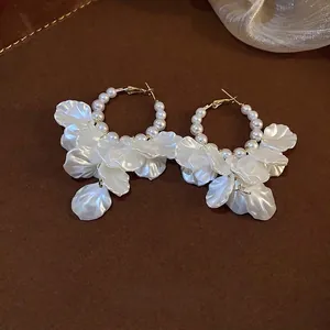 Elegant French style hoop earrings featuring white pearls and frosted petal pendants