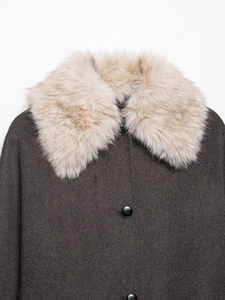 Detailed view of the dark brown jacket featuring a plush faux fur collar and wool texture