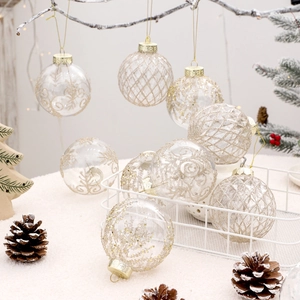 Set of 9 transparent 8cm Christmas balls with gold glitter patterns on snowy branches