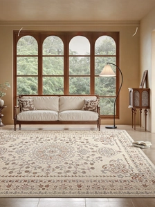 Detail of vintage French floral rug showing elegant cream texture and classical patterns