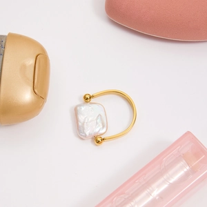 Detailed macro view of 18K gold plated stainless steel ring with a baroque freshwater pearl