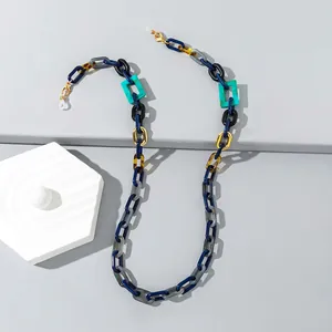 Detail of colorful acrylic eyeglass chain with tortoiseshell and gold geometric links