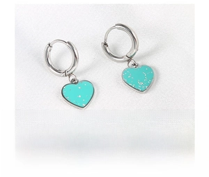 Detail of heart-shaped earrings with Tiffany blue glitter charms on steel hoops