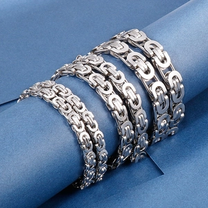 Punk style stainless steel link chains in silver finish shown on a blue background